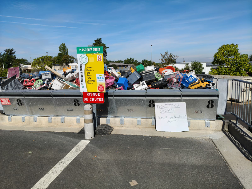 Overflowing skip at a recycling centre